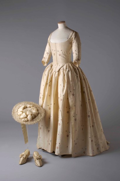 Silk_brocade_gown_hat_and_shoes_1780._Image_reproduced_by_kind_permission_of_the_Olive_Matthews_Collection_Chertsey_Museum._Photograph_by_John_Chase